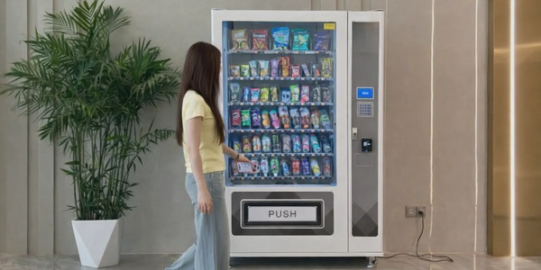A woman selecting a snack from a vending machine indoors.