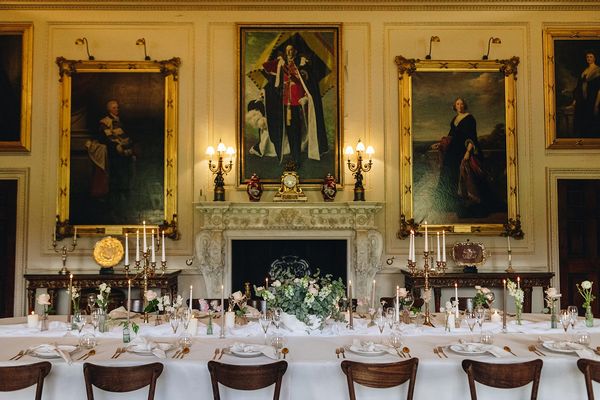 Table dressed with a white tablecloth, runner, bud vases and candles at Harewood House in Yorkshire
