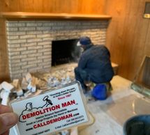 Residential demolition of interior fireplace brick removal.