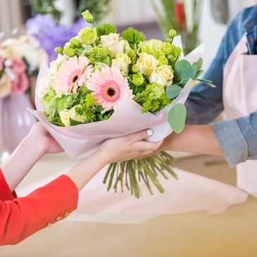 Big beautiful bouquet in soft pastel shades. Florist holding out  a large flowers bouquet 
