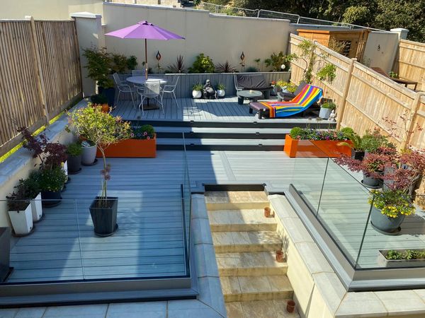 TREX ISLAND MIST DECKING WITH OUR FRAMELESS  GLASS BALUSTRADE