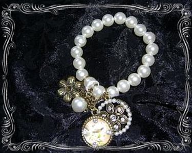 A bracelet with pearl beads and flower charms