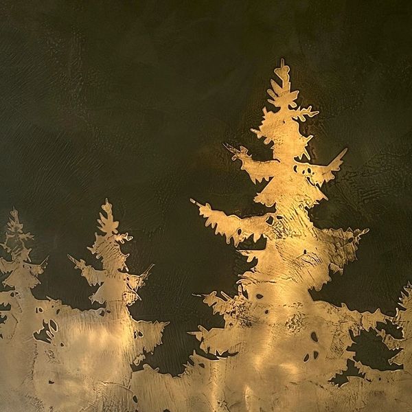 Artistic tree silhouettes in golden tones on a dark background.