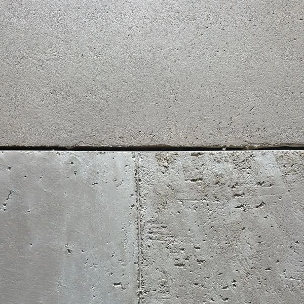 Close-up of concrete slabs with different textures and a visible gap.