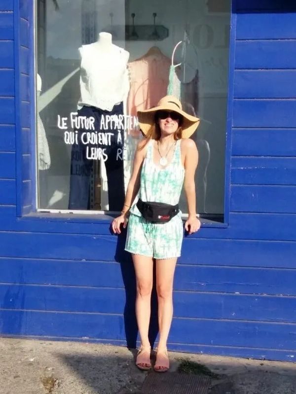Photo of the owner of the boutique, posing outside a shop in Reunion Island