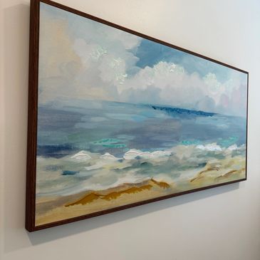 Painting of a serene beach and ocean.