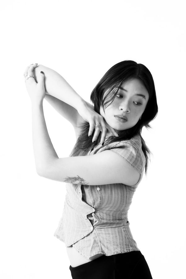Black and white portrait of a woman stretching with grace.