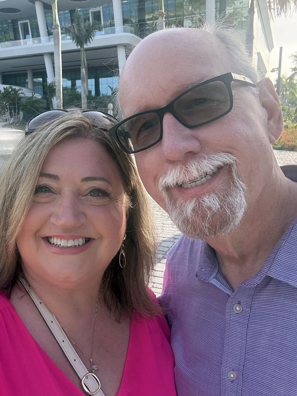 Smiling couple taking a selfie outdoors.