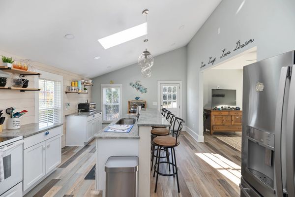 Kitchen with stove, refrigerator, coffee bar, microwave, etc