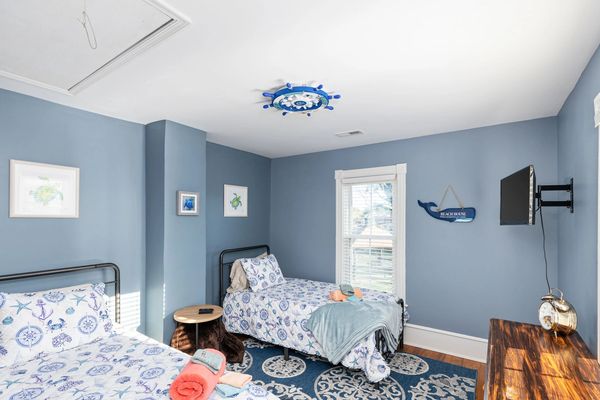 upstairs kids room with two twin beds and smart tv