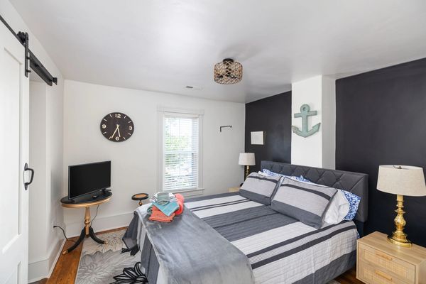Upstairs primary bedroom with ensuite bathroom, queen bed and smart tv
