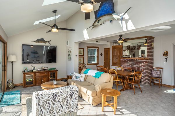 Cozy den with smart tv, adjacent to dining room and kitchen.