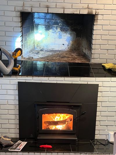 Before and After Pictures of installing a wood stove insert into an existing fireplace