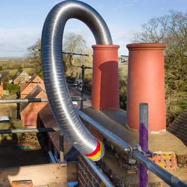 Metal Chimney Liner being installed in chimney flue on home located in Staunton