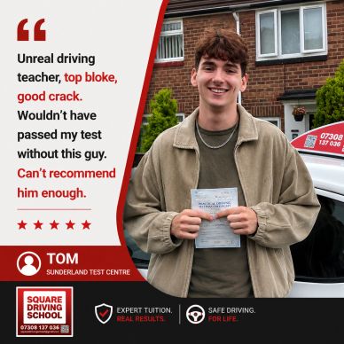 Young man proudly holding driving test pass certificate.
