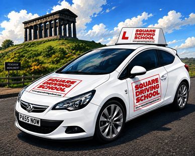 White driving school car near Penshaw Monument on a sunny day.