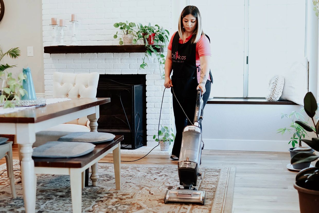 girl vacuuming dining room 
