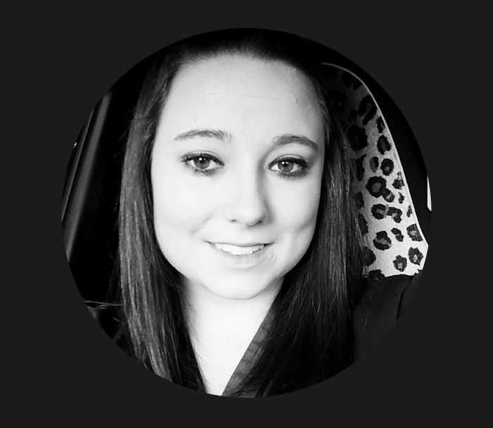 Black and white portrait of a smiling woman with long hair.