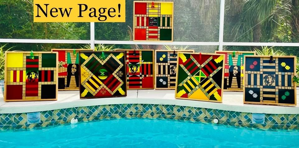 Colorful handmade game boards displayed by a pool with a "New Page!" sign.