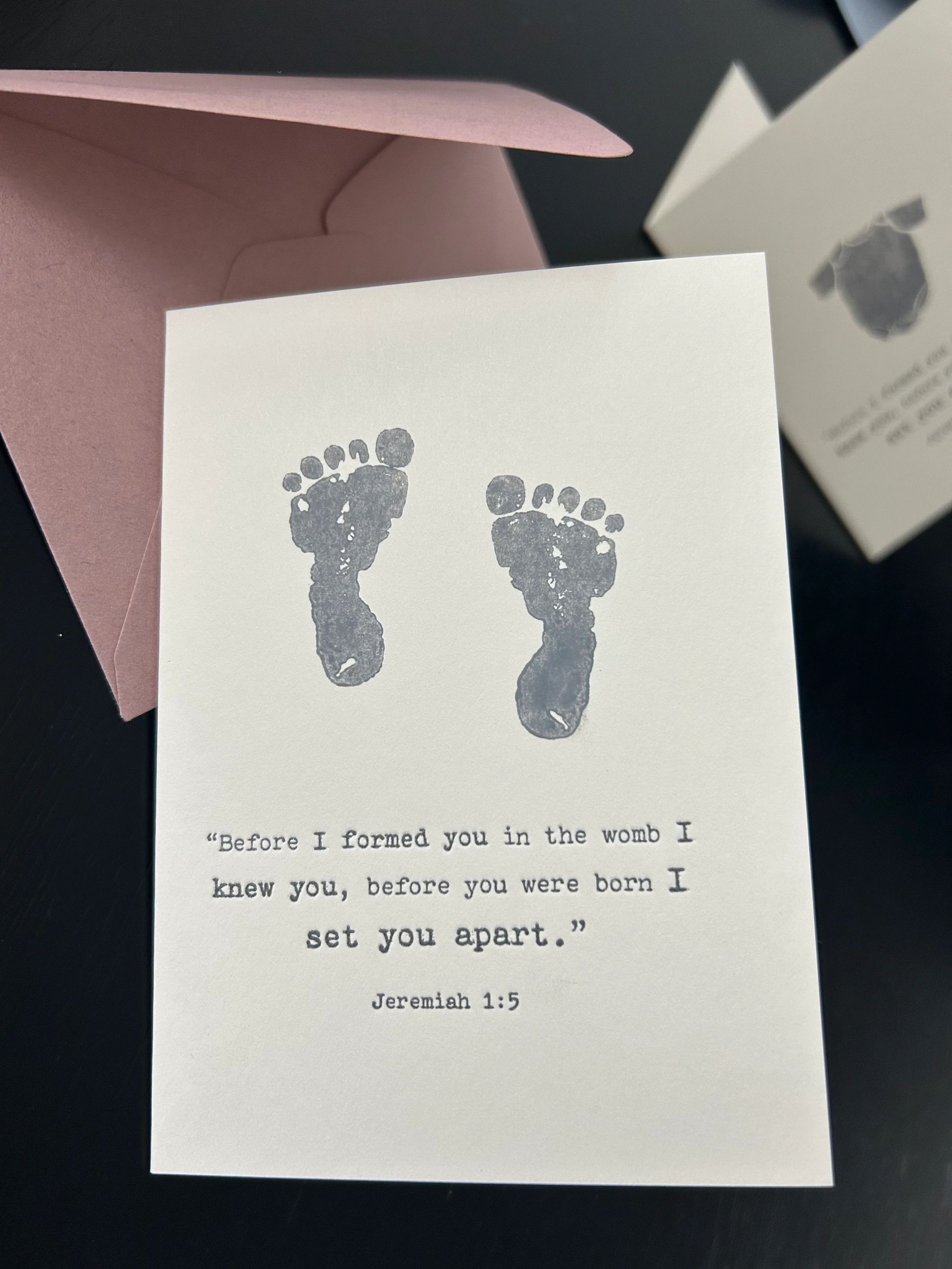 Card with baby footprints and biblical quote.