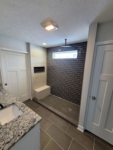 Tiled shower with rain shower head.