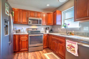 Kitchen with wood cabinets of the Brandi Marie Blueprint.