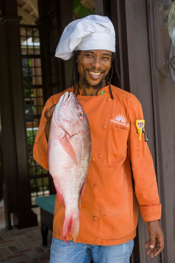 destination photography in Jamaica of resort chef holding fish of the day