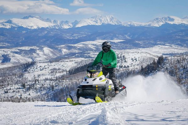 commercial brand photography for resort in Colorado with snowmobile and winter activities