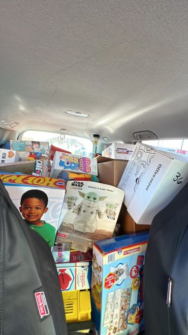 Car filled with toys and boxes.