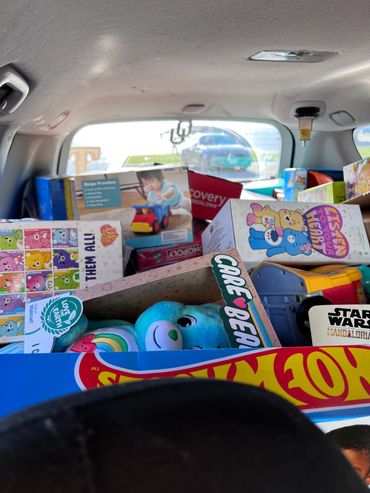 Back of a vehicle filled with toys and games.