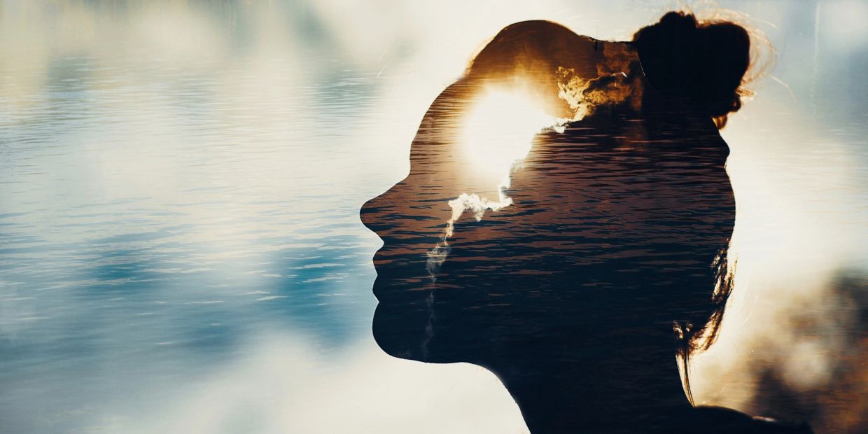 Silhouette of a woman with nature elements overlapping.
