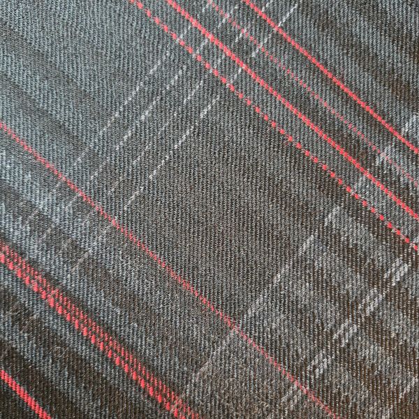 Gray fabric with red and white plaid pattern.
