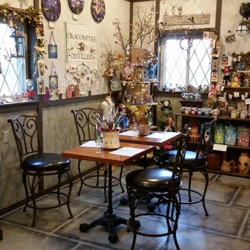 chairs and tables with gift items in the background