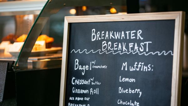 Chalkboard menu displaying breakfast items at Breakwater Breakfast.