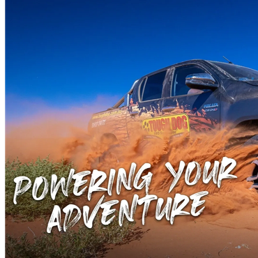 4WD DRIVING THROUGH DUSTY PADDOCK WITH TOUGH DOG LOGO ON THE SIDE