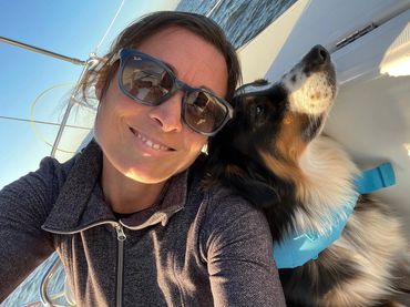 Selfie of woman with dog on sailboat