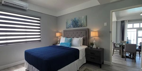 Cozy bedroom with navy blue bedding and modern decor.