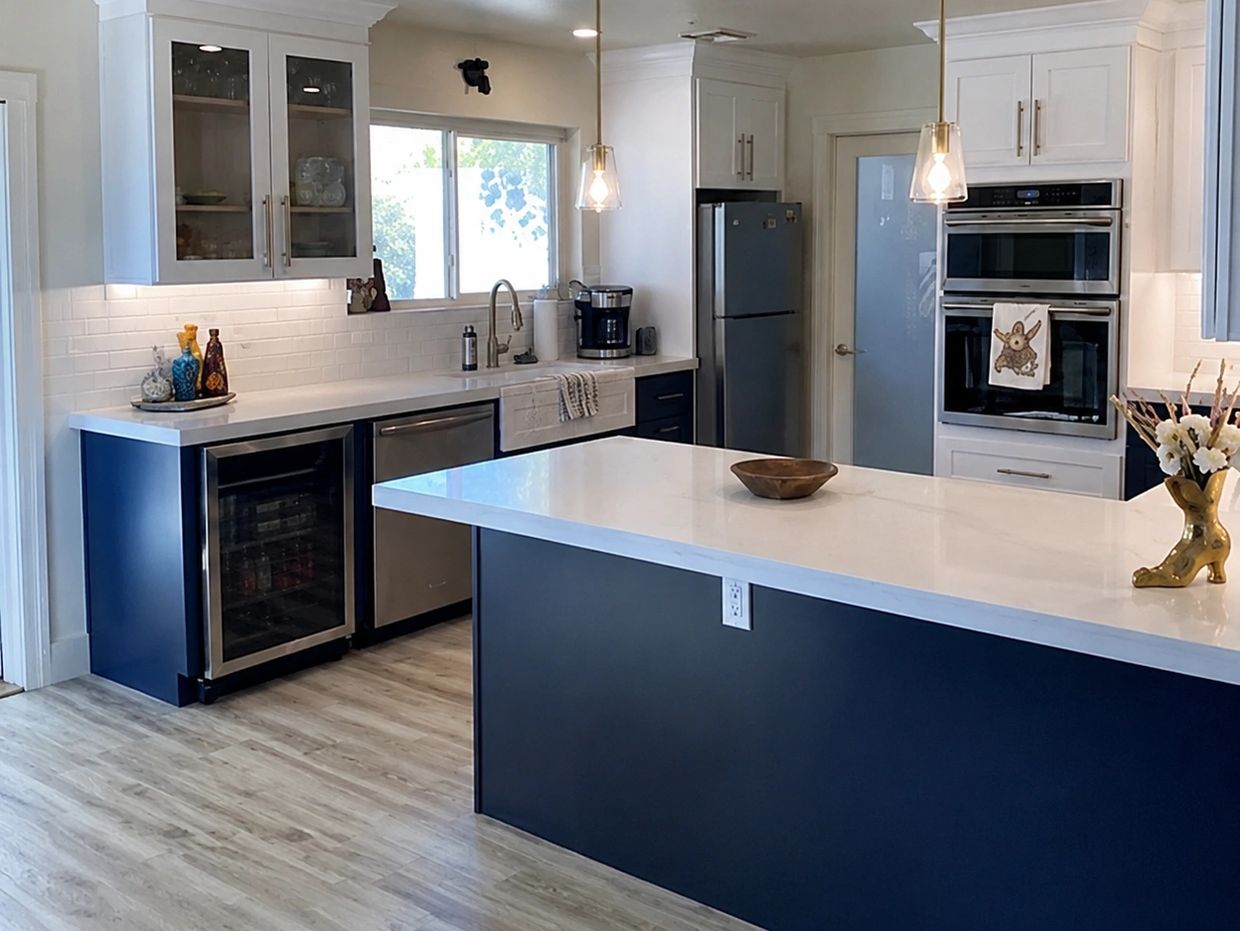 Modern kitchen with blue and white cabinetry and a large island.