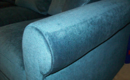 Close up of upholstered roll arm