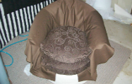 Fabric is draped over chair