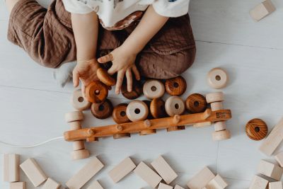Child using toys to communicate and express emotions through therapeutic play