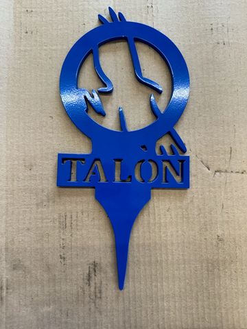 Blue metal sign with a bird and the word TALON.