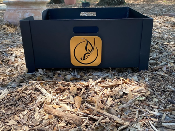 Black wooden crate with butterfly logo on wood chips.