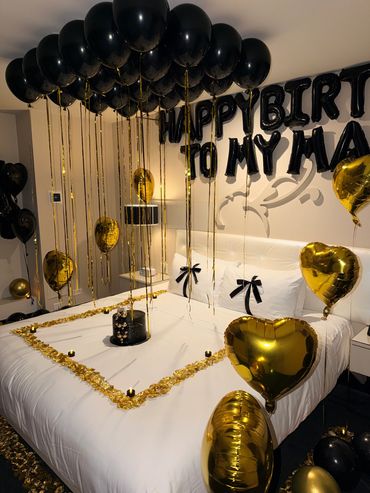 Black and gold themed bedroom birthday decoration.