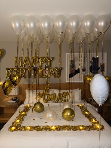 Gold and white themed bedroom birthday decoration.