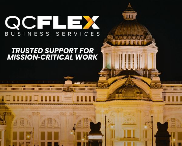 QC Flex Business Services logo with illuminated historic building at night.