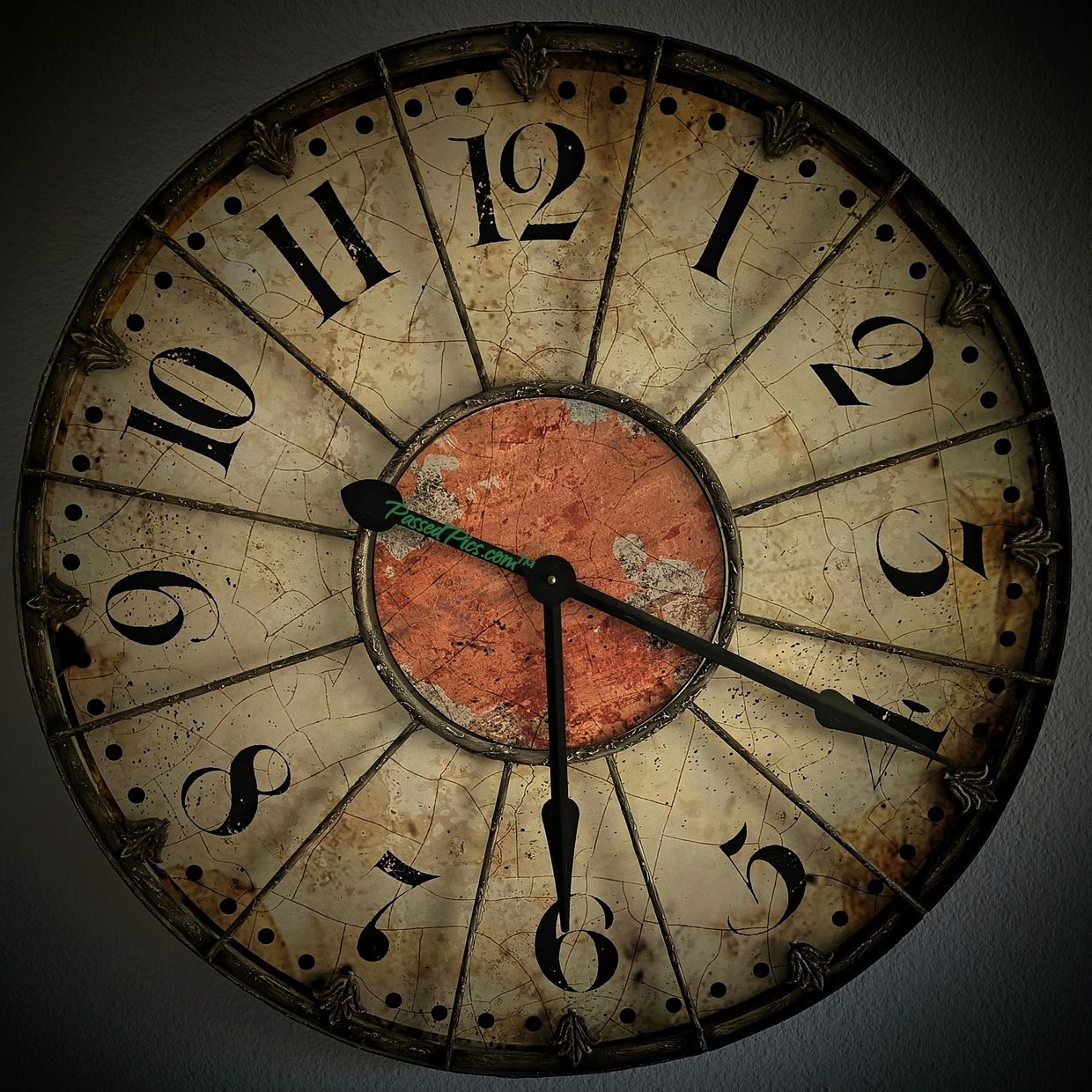 6:20pm displayed on a large beige red & bronze highly detailed rustic antique over-sized wall clock.