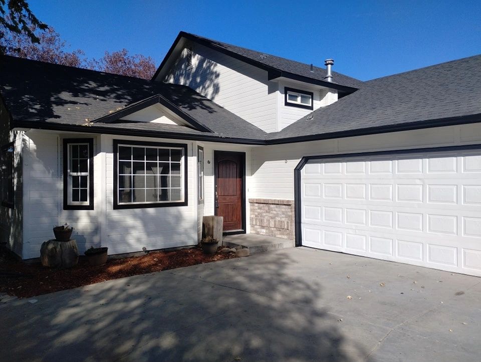 Exterior of a house painted bright white with black trim.