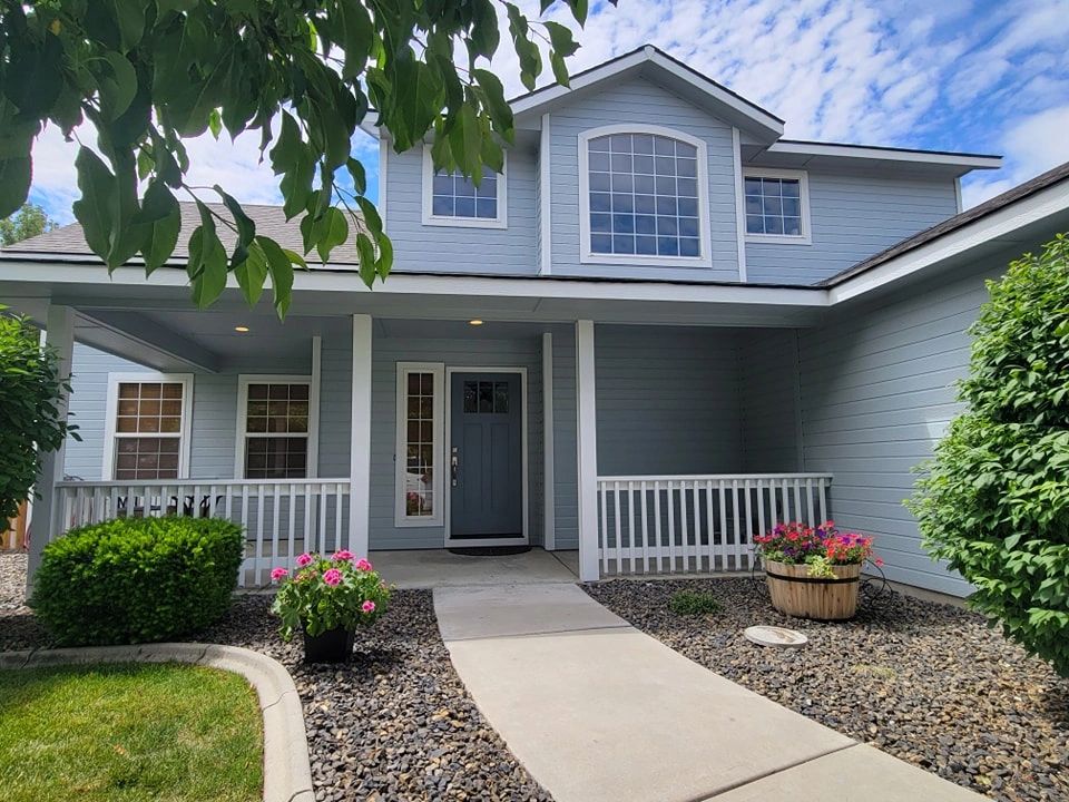 Exterior of a house painted in light gray with white trim.