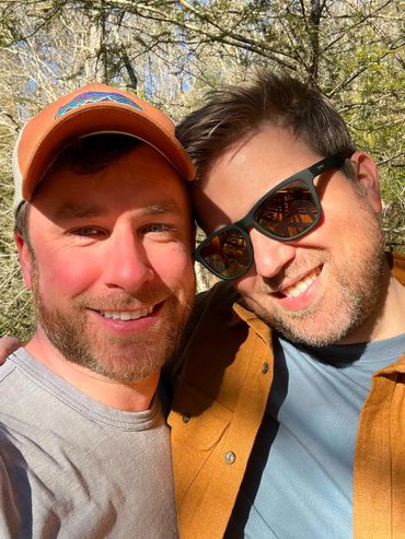 Husbands Todd and Rob smiling in winter North Georgia forest